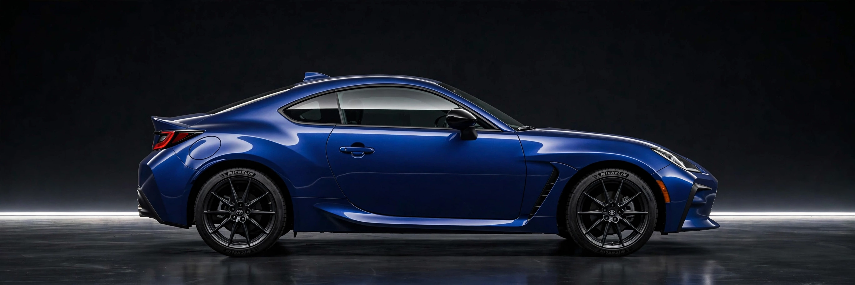 GR86 side profile in a dark studio